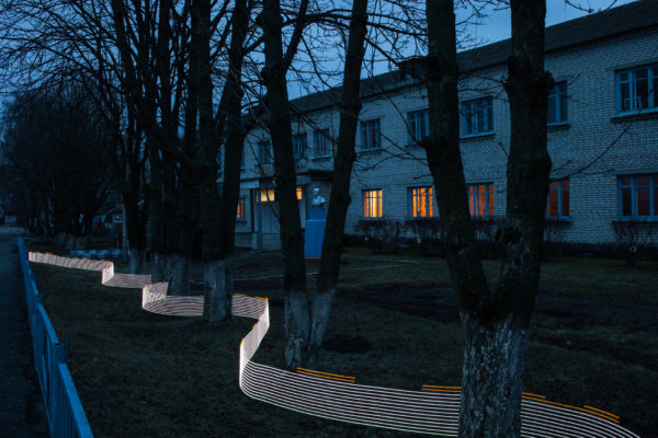 A special light painting tool displays radiation levels in real-time at a school in Starye Bobovichi (Старые Бобовичи). Here white light shows contamination levels up to 0.23uSv/h, while orange highlights elevated levels – up to 0.30uSv/h around these trees. 30 years after the 1986 Chernobyl nuclear disaster, the schoolyard still contains areas of elevated radiation levels. This image has not been digitally manipulated outside of minor contrast and exposure adjustments. Greenpeace/Greg McNevin