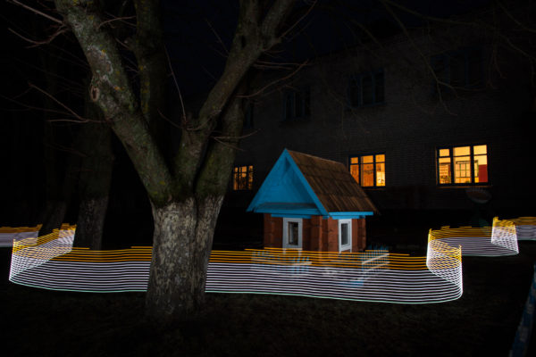 A special light painting tool displays radiation levels in real-time at a school in Starye Bobovichi (Старые Бобовичи). Here white light shows contamination levels up to 0.23uSv/h (Japan’s guide for decontamination), while orange highlights elevated levels – from 0.30uSv/h to 0.65uSv/h around these trees and children's play house. 30 years after the 1986 Chernobyl nuclear disaster, the schoolyard still contains areas of elevated radiation levels. This image has not been digitally manipulated outside of minor contrast and exposure adjustments. Greenpeace/Greg McNevin